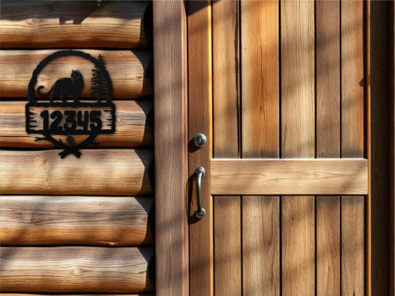 Cabin cougar address sign with pine trees
