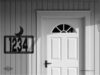 steel house number sign with moon silhouette