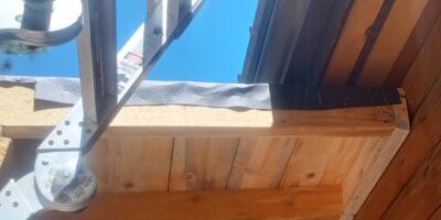 Roofing felt wrapped over the roof edge before the rustic trim was fastened in place.
